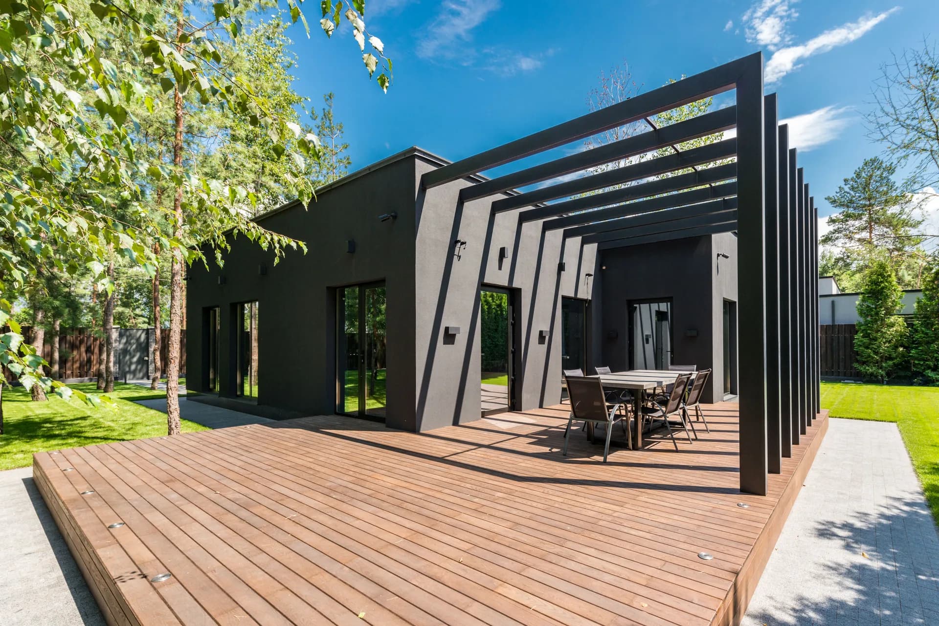 Modern dark house exterior with a wood deck