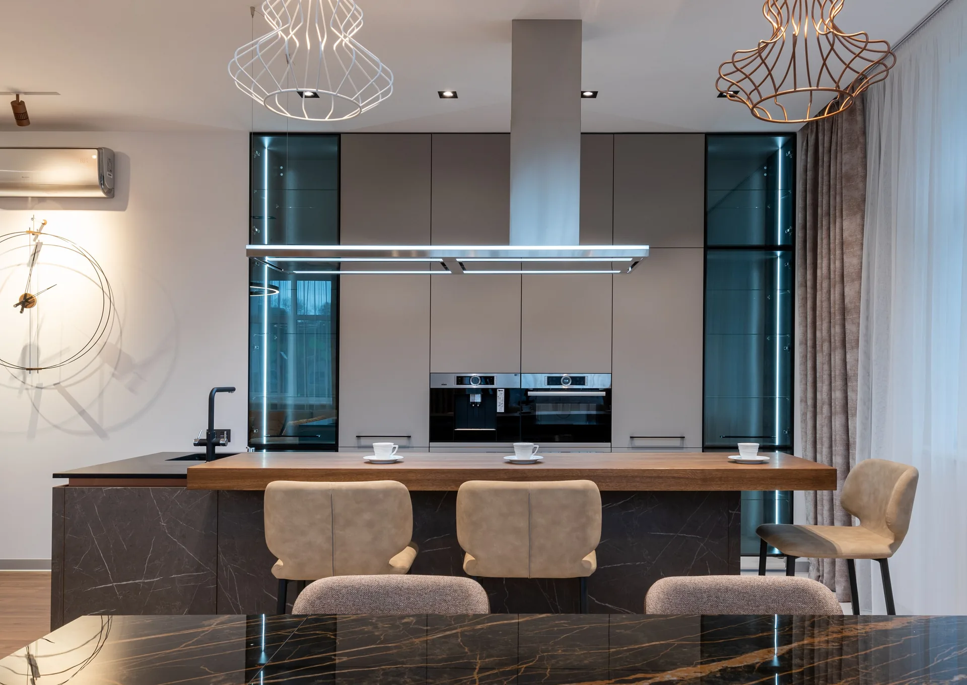 Modern kitchen with dark cabinetry and stone surfaces