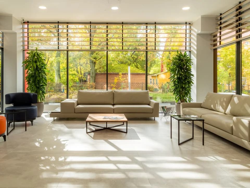 Bright modern living room with wide windows and light walls.